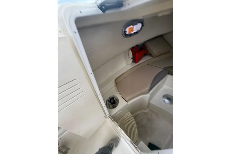 Slide: The Image of Interior cabin of 2012 Boston Whaler 255 Conquest boat, featuring seating and storage. - 26