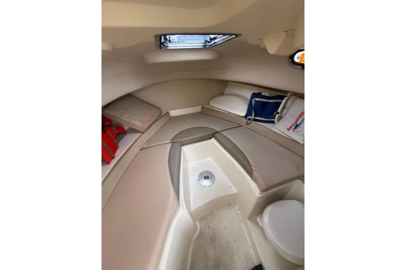 Slide: The Image of Interior cabin of 2012 Boston Whaler 255 Conquest boat, featuring seating and storage. - 27