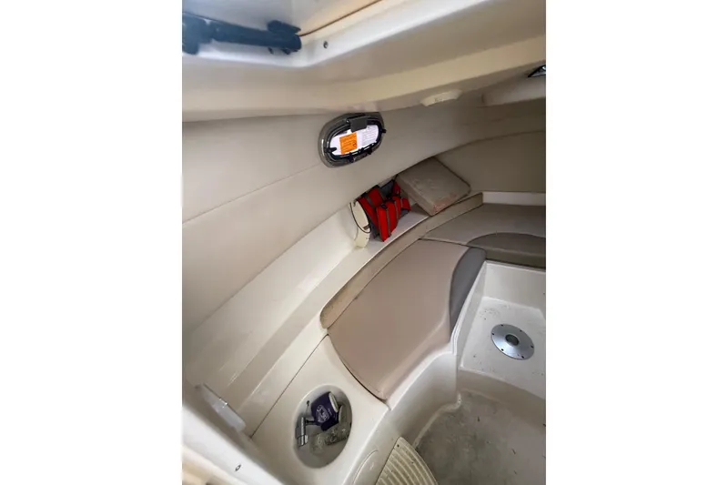 Slide: The Image of Interior cabin of 2012 Boston Whaler 255 Conquest boat, featuring seating and storage. - 28