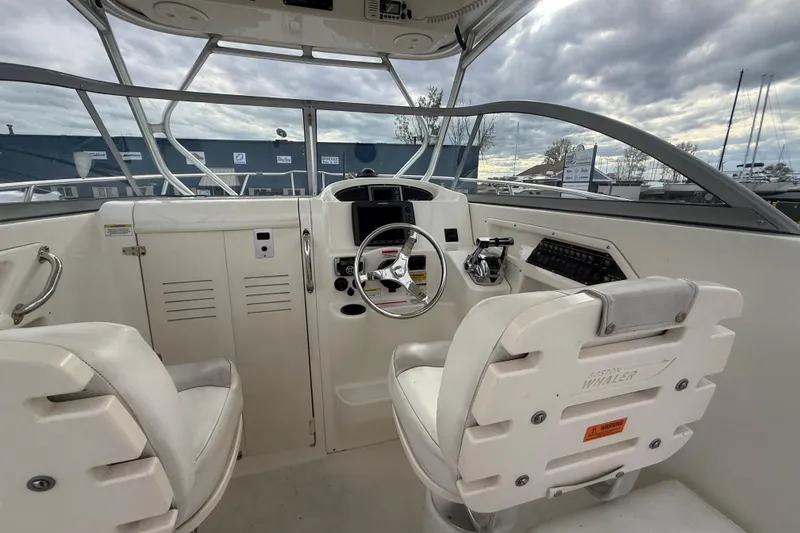 Slide: The Image of Interior view of a 2012 Boston Whaler 255 Conquest boat cockpit with steering wheel. - 31