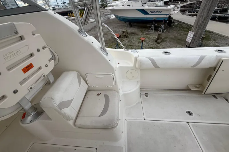 Slide: The Image of Interior view of a 2012 Boston Whaler 255 Conquest boat, showcasing seating and deck area. - 33