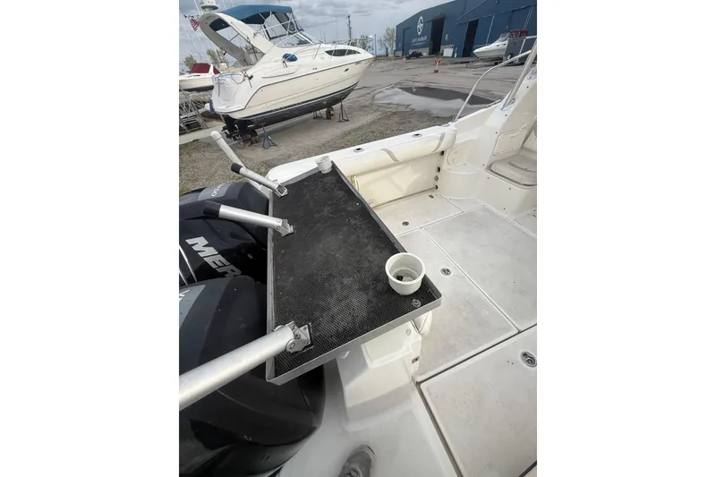 Slide: The Image of 2012 Boston Whaler 255 Conquest boat deck with fishing rod holders and cup holder. - 36