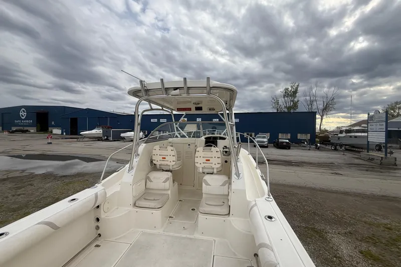 Slide: The Image of 2012 Boston Whaler 255 Conquest boat at marina under cloudy sky. - 9