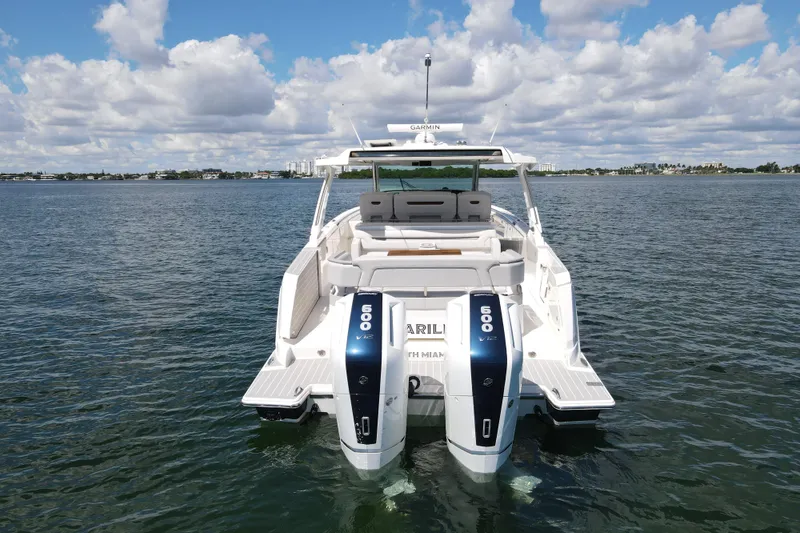Slide: The Image of 2024 Tiara Yachts 43 LS on water, featuring dual 600 V12 engines, clear sky backdrop. - 10