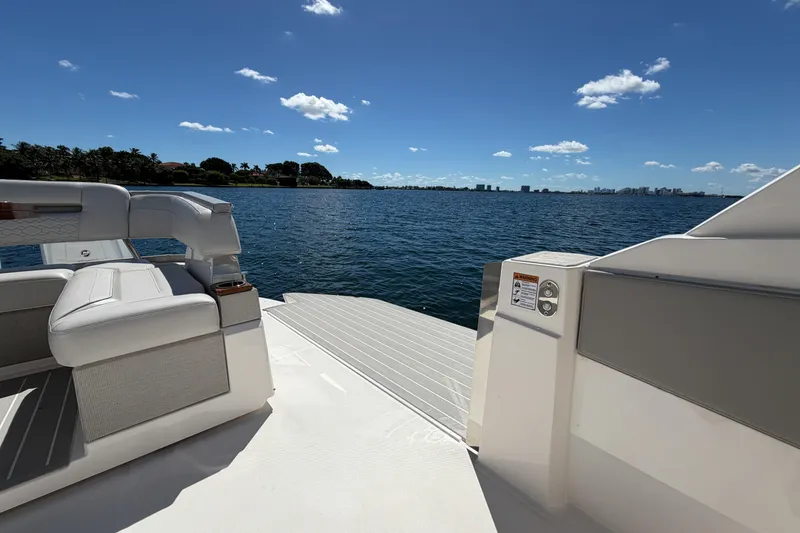 Slide: The Image of 2024 Tiara Yachts 43 LS on calm water, featuring luxurious seating and scenic ocean view. - 14