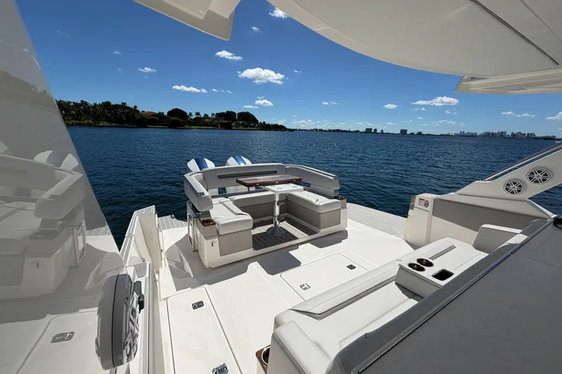 Slide: The Image of Luxurious 2024 Tiara Yachts 43 LS with elegant seating, overlooking serene blue waters. - 17