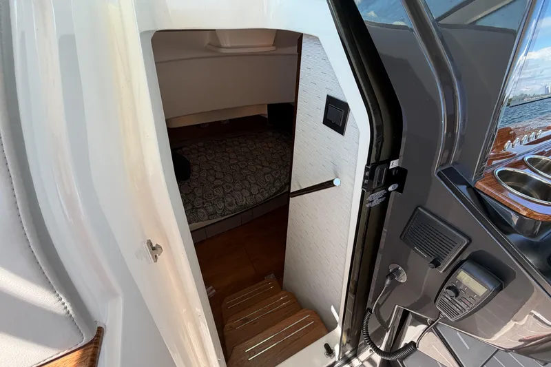 Slide: The Image of 2024 Tiara Yachts 43 LS cabin entrance with wooden steps and interior view. - 34