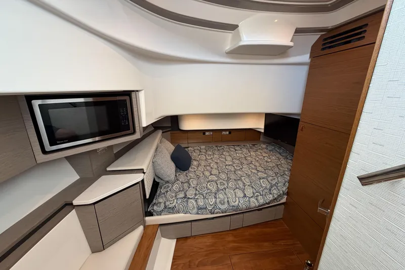 Slide: The Image of Luxurious cabin interior of 2024 Tiara Yachts 43 LS with bed and microwave. - 35