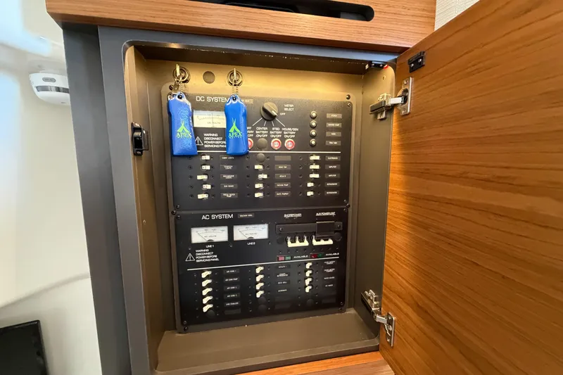 Slide: The Image of Electrical panel inside 2024 Tiara Yachts 43 LS, featuring AC and DC systems. - 38