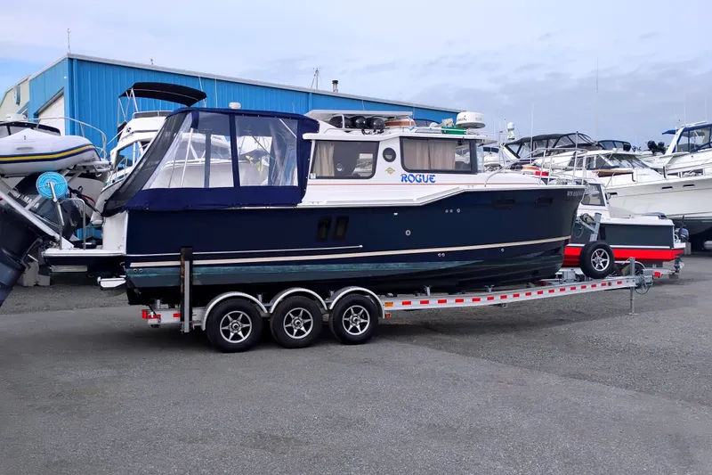 The Image of 2021 Ranger Tugs R-27 boat on trailer at marina. - 1