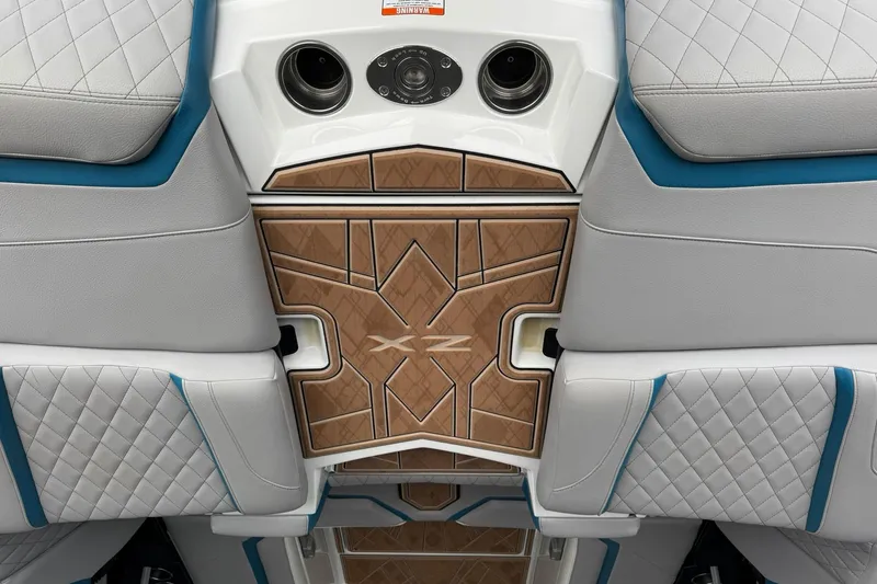 Slide: The Image of 2023 Tigé 25ZX boat interior with quilted seats and stylish wood paneling. - 13