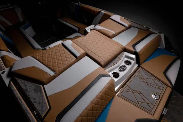 Slide: The Image of Manufacturer Provided Image: 2023 Tigé 25ZX boat interior with luxurious brown and white quilted seats. - 18