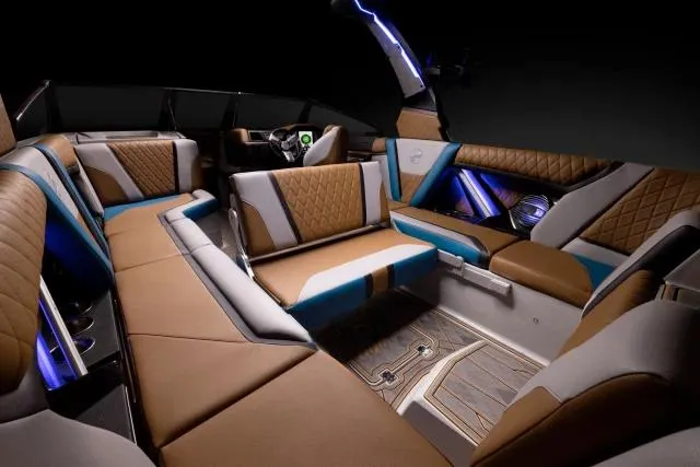 Slide: The Image of Manufacturer Provided Image: 2023 Tigé 25ZX boat interior with luxurious brown and blue seating, ambient lighting. - 24