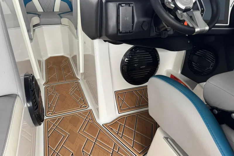 Slide: The Image of 2023 Tigé 25ZX boat interior with stylish flooring and modern steering console. - 25