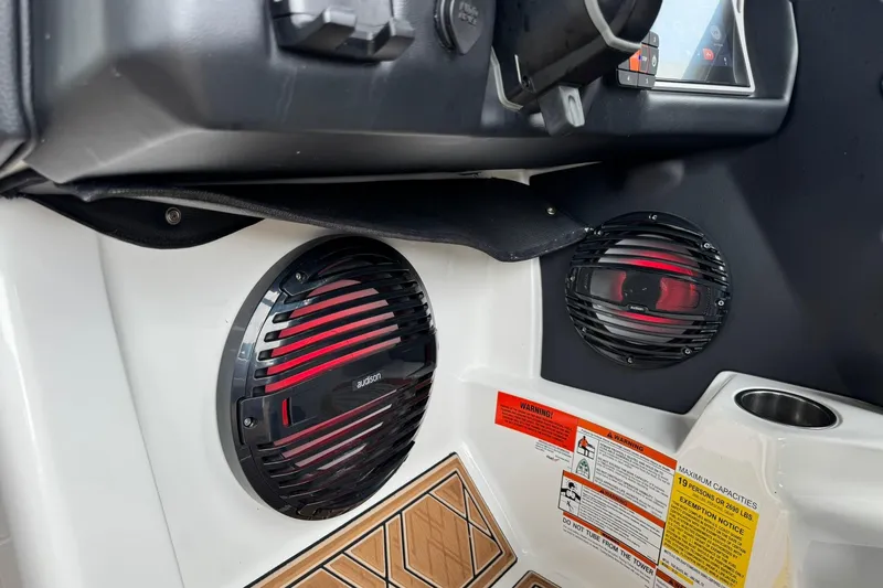 Slide: The Image of 2023 Tigé 25ZX boat interior featuring Audison speakers and control panel. - 26