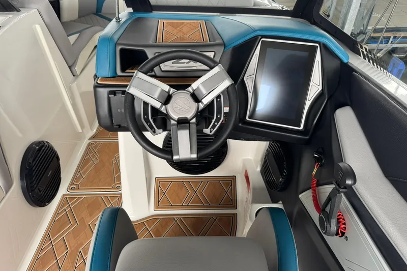 Slide: The Image of 2023 Tigé 25ZX boat cockpit with modern steering wheel and touchscreen display. - 27