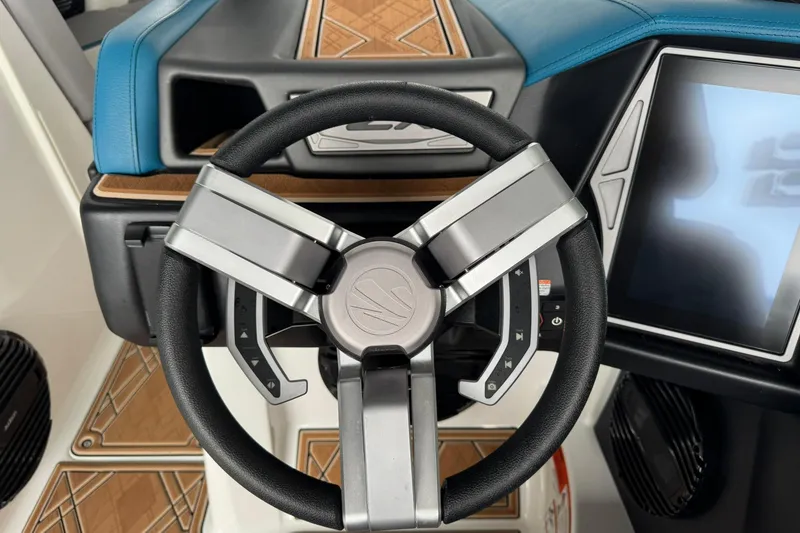 Slide: The Image of 2023 Tigé 25ZX boat steering wheel and dashboard with modern controls. - 28