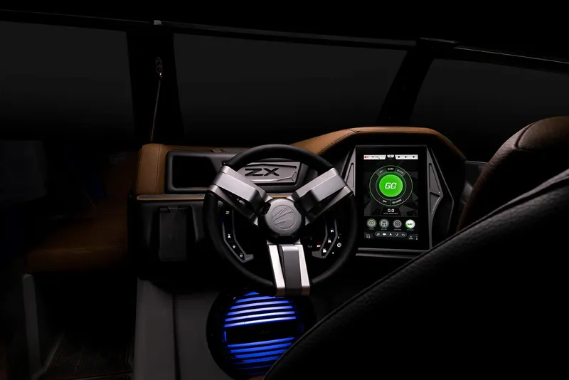 Slide: The Image of Manufacturer Provided Image: 2023 Tigé 25ZX boat dashboard with steering wheel and touchscreen display. - 29