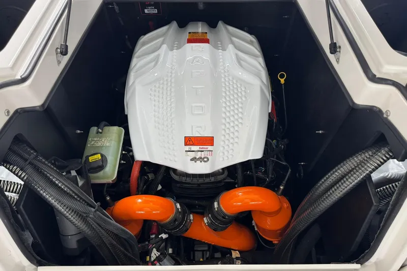 Slide: The Image of 2023 Tigé 25ZX boat engine with Raptor cover and orange hoses. - 34