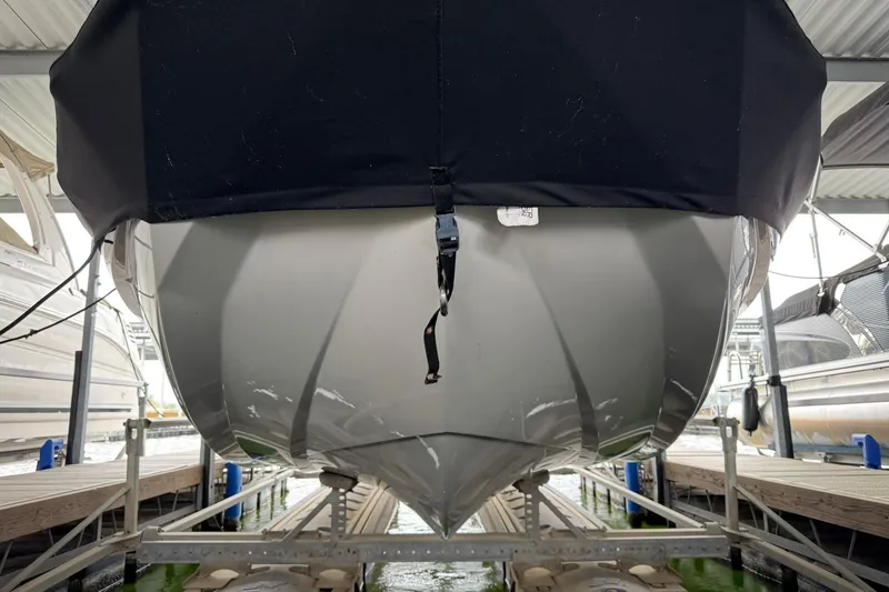 Slide: The Image of 2023 Tigé 25ZX boat hull in covered dock, showcasing sleek design and craftsmanship. - 37
