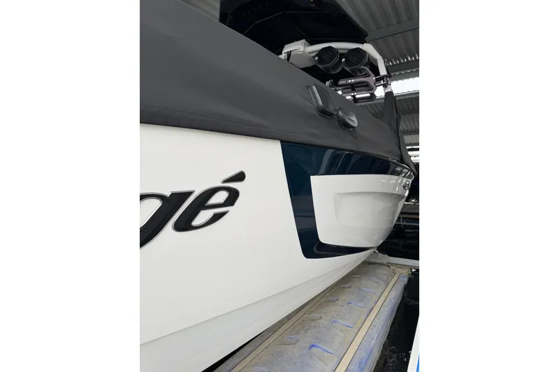 Slide: The Image of 2023 Tigé 25ZX boat in storage, showcasing sleek design and branding. - 4