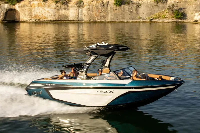 Slide: The Image of Manufacturer Provided Image: 2023 Tigé 25ZX boat cruising on a lake with passengers. - 5