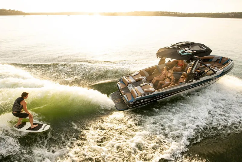 Slide: The Image of Manufacturer Provided Image: 2023 Tigé 25ZX boat with people wake surfing on a sunny lake. - 7