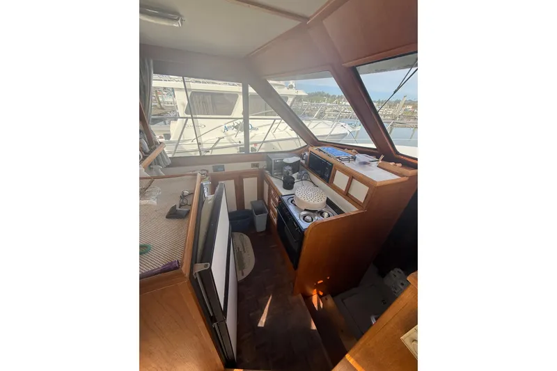 Slide: The Image of Interior view of 1990 Cooper Prowler boat with kitchen and navigation area. - 10