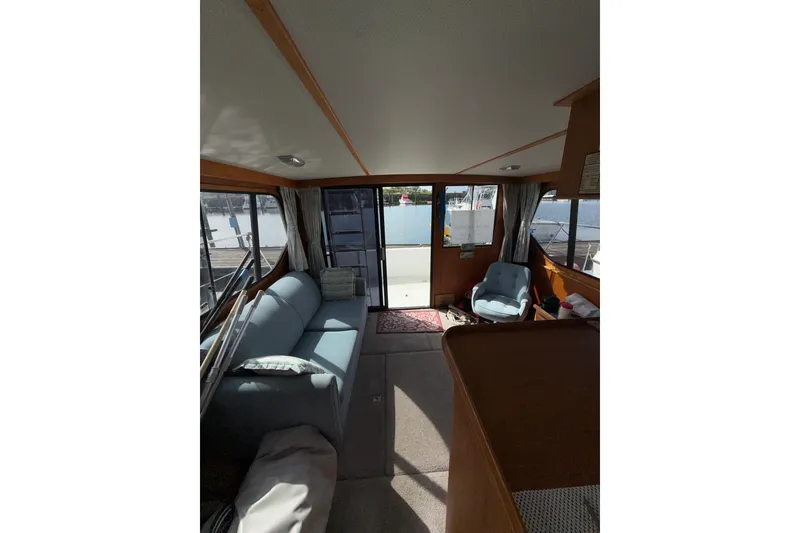 Slide: The Image of Interior of 1990 Cooper Prowler boat with cozy seating and waterfront view. - 16