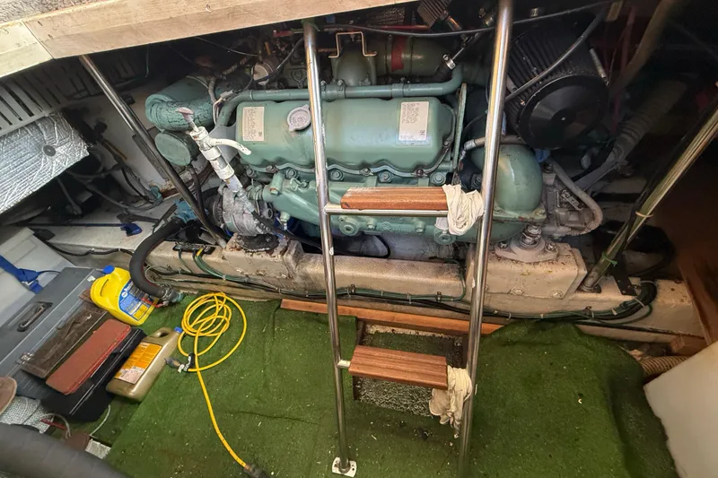 Slide: The Image of Engine room of a 1990 Cooper Prowler boat with visible machinery and tools. - 18