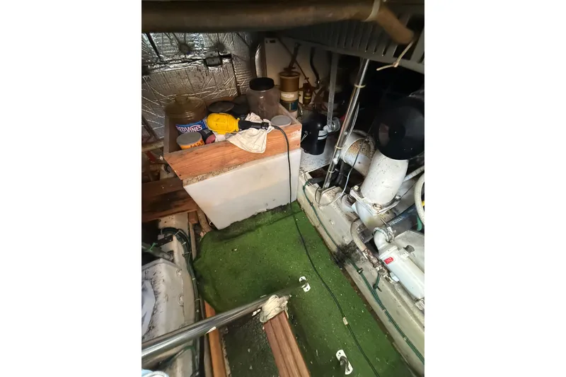 Slide: The Image of Engine room of a 1990 Cooper Prowler boat with tools and equipment. - 19