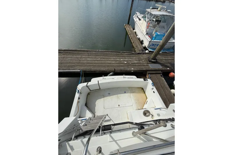 Slide: The Image of 1990 Cooper Prowler boat docked at marina, viewed from above. - 21