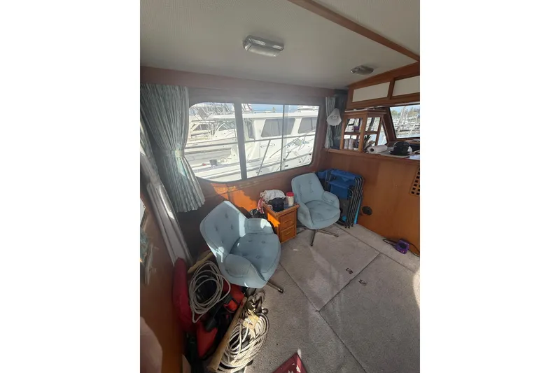Slide: The Image of Interior of 1990 Cooper Prowler boat with chairs and nautical equipment. - 6