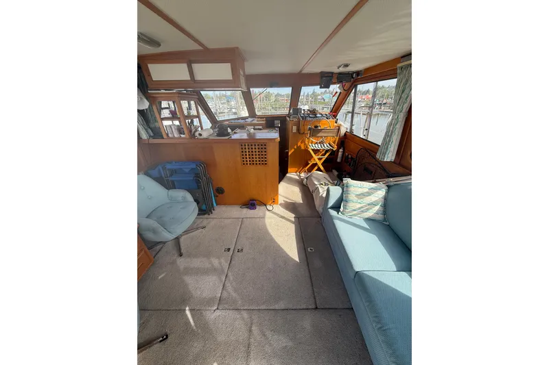 Slide: The Image of Interior of a 1990 Cooper Prowler boat with cozy seating and wooden accents. - 8