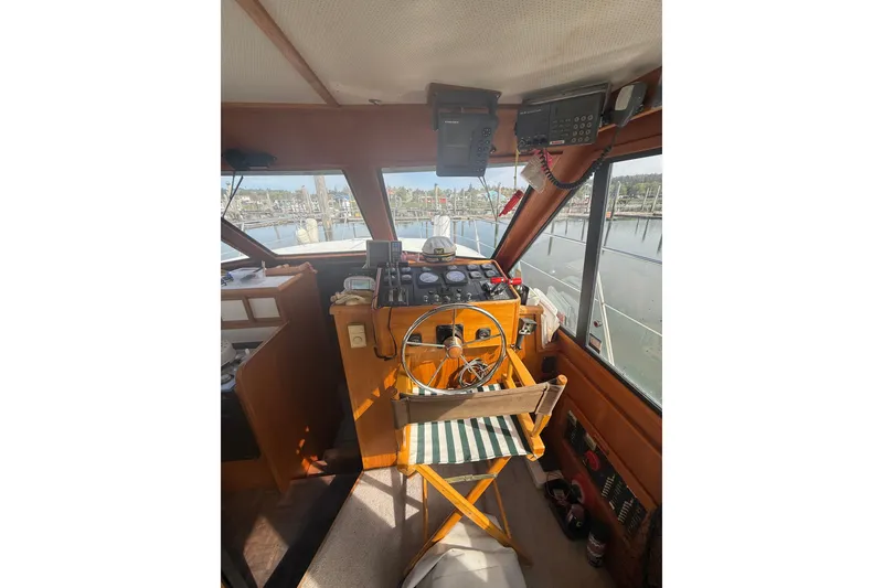 Slide: The Image of Interior view of 1990 Cooper Prowler boat cockpit with steering wheel and navigation equipment. - 9
