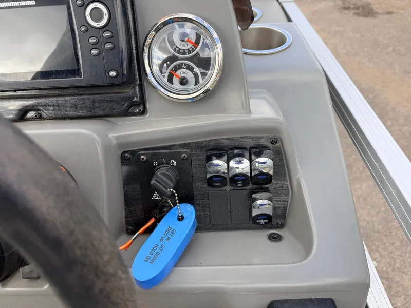 Slide: The Image of Dashboard of a 2022 Tahoe Sport 2080 CRB boat with switches and gauges. - 22