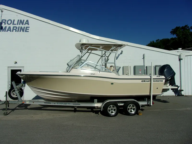 Slide: The Image of 2014 Grady-White Freedom 225 boat on trailer outside building. - 3