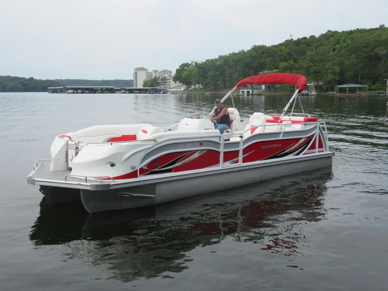 The Image of 2014 JC Sporttoon 26TT pontoon boat on a calm lake. - 1