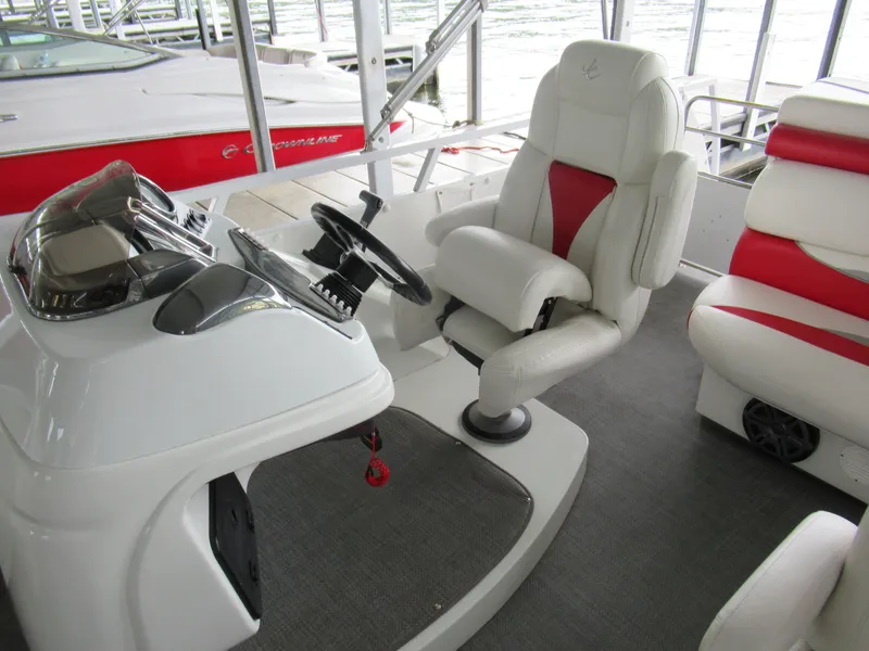 Slide: The Image of Interior of a 2014 JC Sporttoon 26TT boat with white and red seating. - 15
