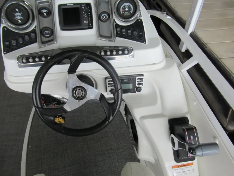 Slide: The Image of Dashboard of a 2014 JC Sporttoon 26TT boat with steering wheel and instruments. - 16