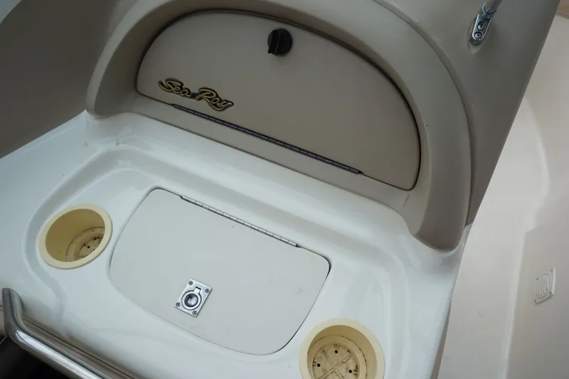 Slide: The Image of Interior of a 1998 Sea Ray 210 Signature boat with blue carpeting. - 10