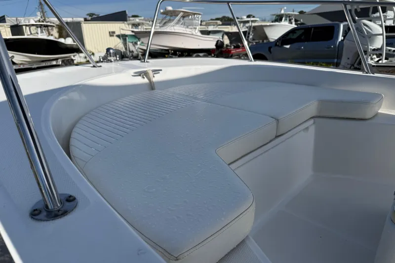 Slide: The Image of 2015 Boston Whaler 170 Montauk boat interior with cushioned seating. - 10