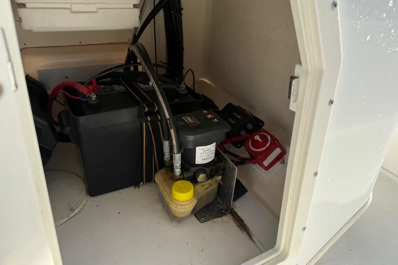 Slide: The Image of 2015 Boston Whaler 170 Montauk battery compartment with wiring and switch. - 12