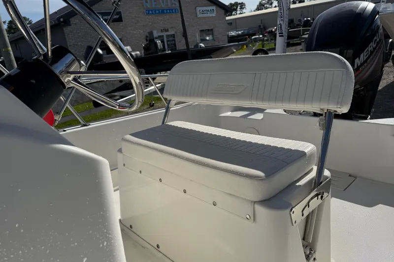 Slide: The Image of 2015 Boston Whaler 170 Montauk boat interior with steering wheel and cushioned seating. - 13