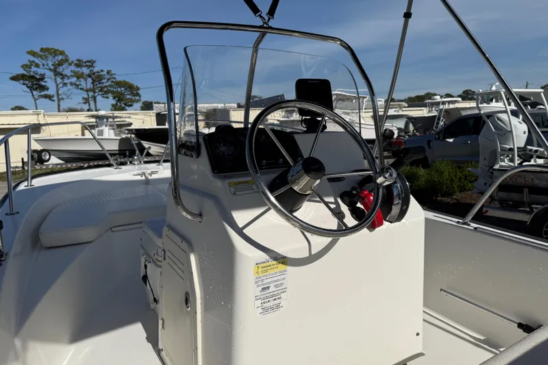 Slide: The Image of 2015 Boston Whaler 170 Montauk boat console with steering wheel and controls. - 17