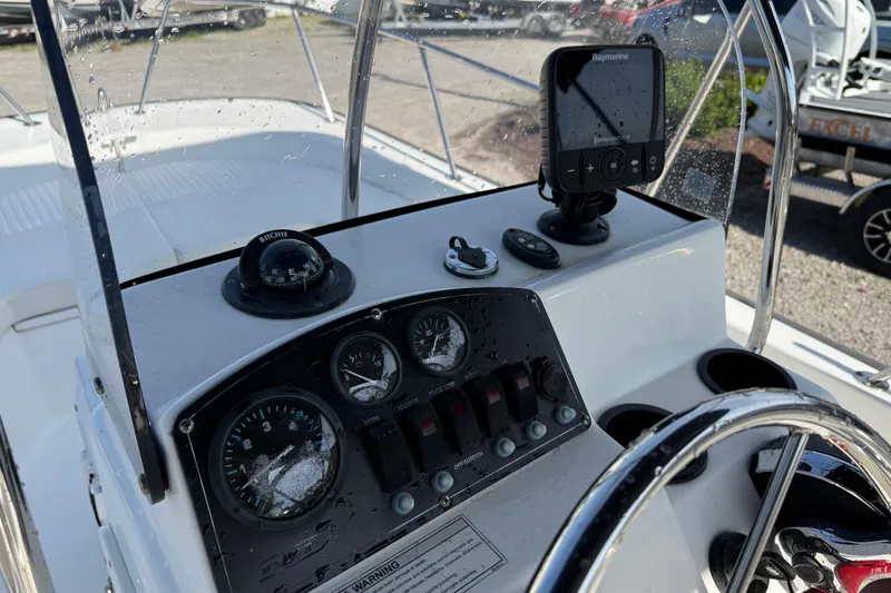 Slide: The Image of 2015 Boston Whaler 170 Montauk boat dashboard with gauges and navigation equipment. - 18