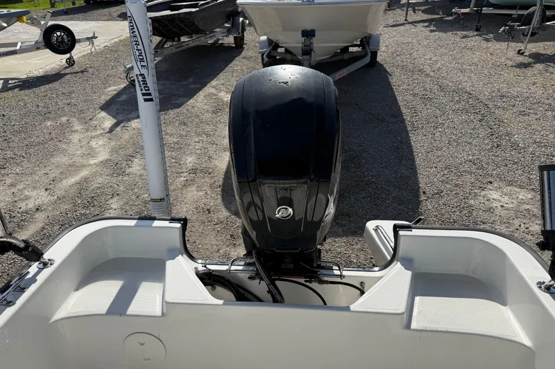 Slide: The Image of 2015 Boston Whaler 170 Montauk boat with outboard motor, parked on gravel. - 21