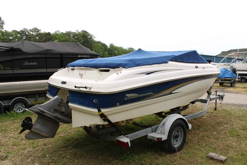 Slide: The Image of 2002 Chaparral Volvo Penta SX boat on trailer, blue and white, covered. - 5