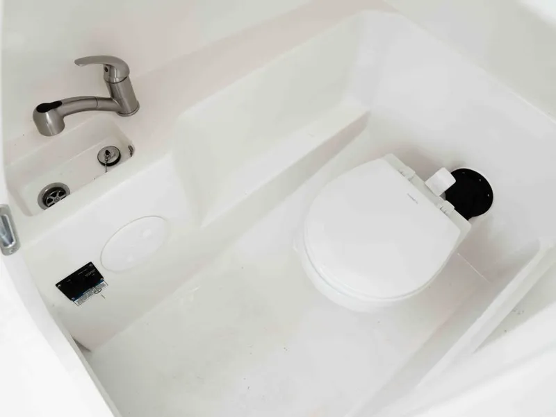 Slide: The Image of Interior of 2022 Boston Whaler 240 Vantage with toilet and sink. - 20