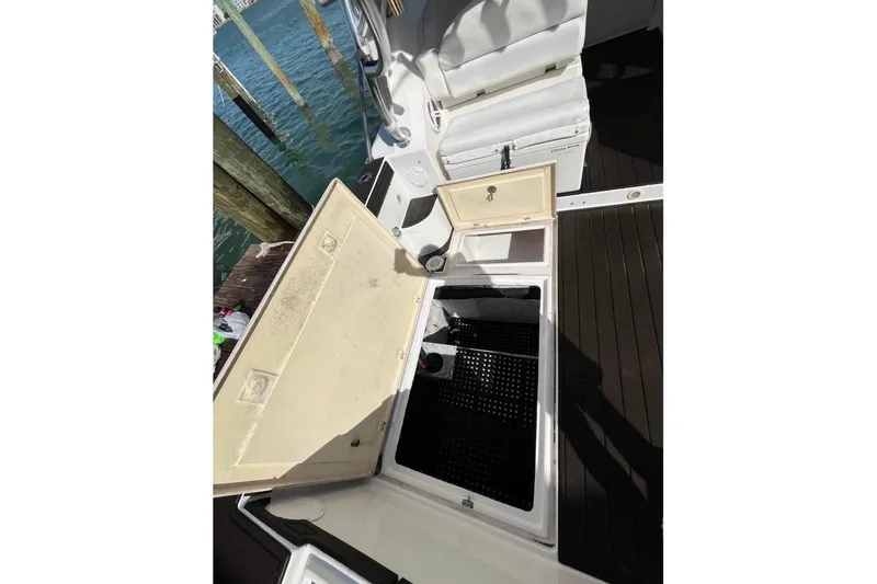 Slide: The Image of Open storage compartment on 2008 ProKat 3660 Sport Fish boat, dockside view. - 13